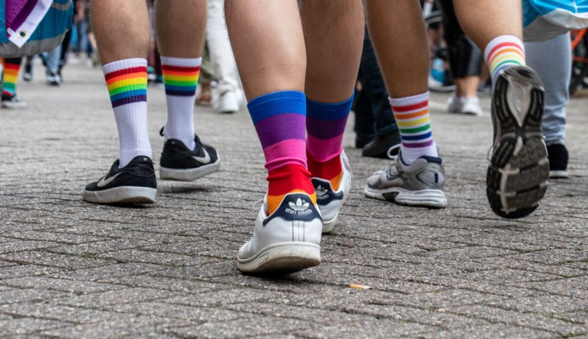 People with rainbow socks walking on the street