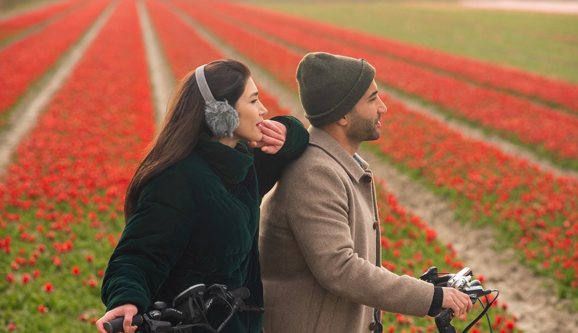 People on a bike near the flower fields