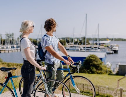 Couple on bikes looking out over Lauwersmeer 