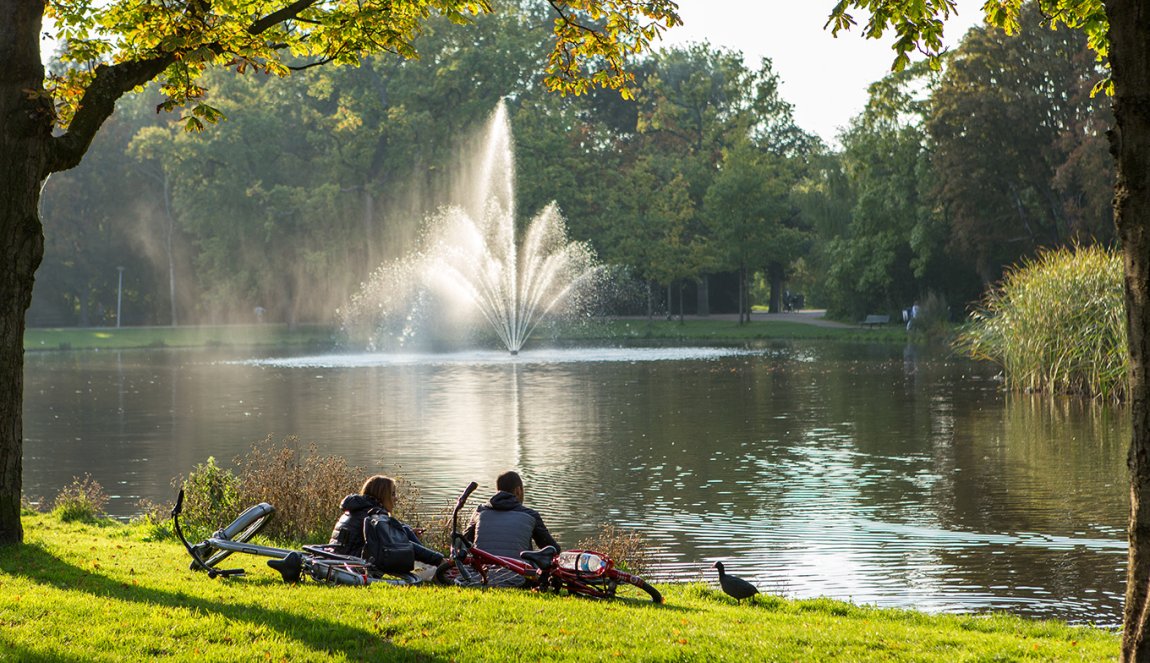 Amsterdam Vondelpark people sitting on waterfront