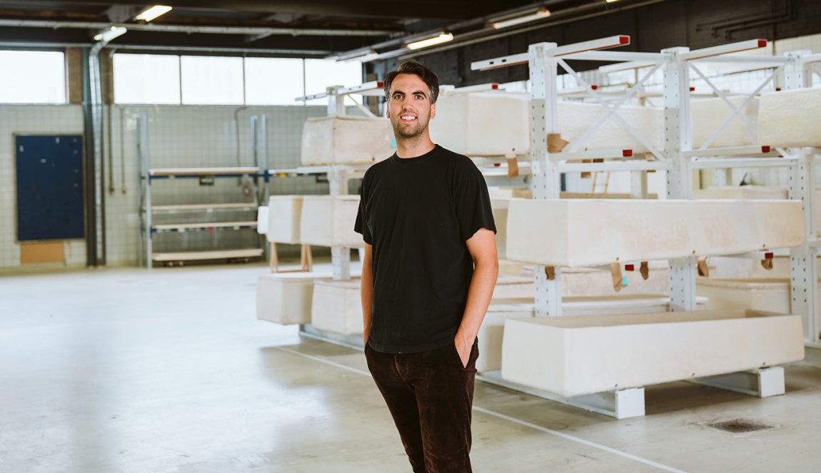 Studio Hendrikx Bob in front of a rack of environmentally friendly coffins 