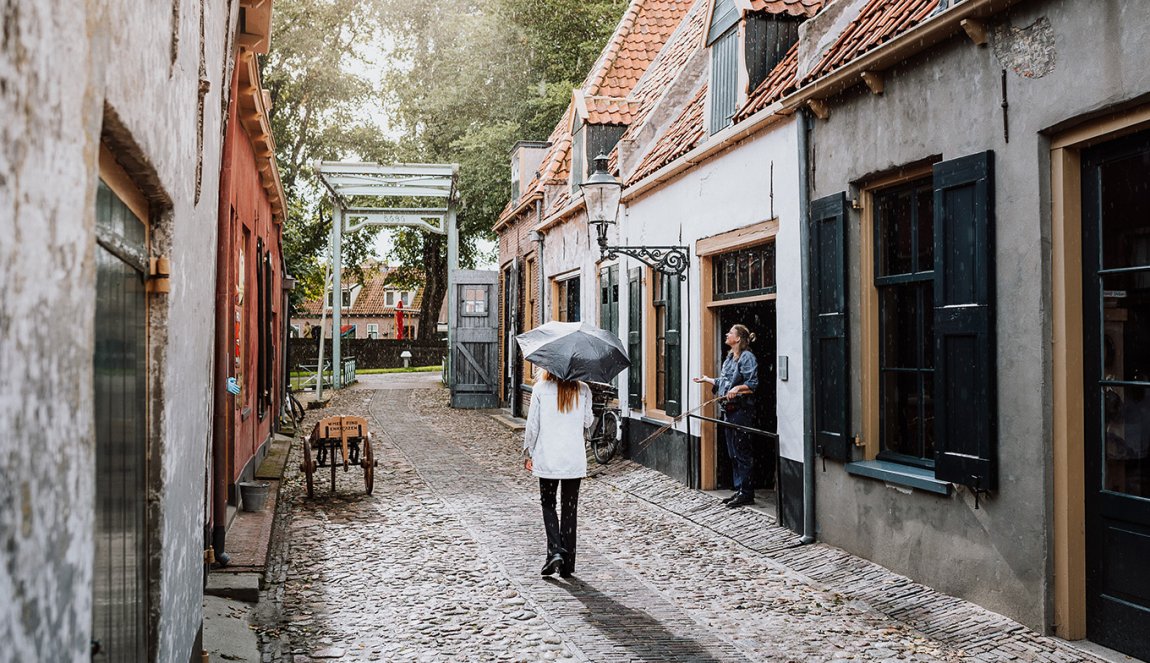 Lady walks through characteristic street Enkhuizen