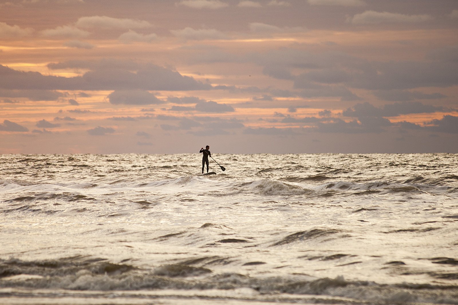 Supper on rough sea in evening near coast of South Holland