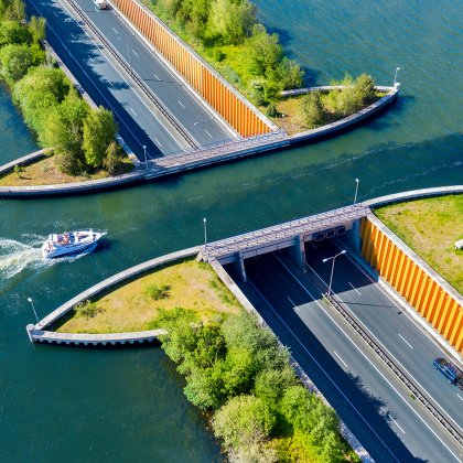 Aquaduct Veluwemeer, aerial view from the drone. A sailboat sails through the aqueduct on the lake above the highway.