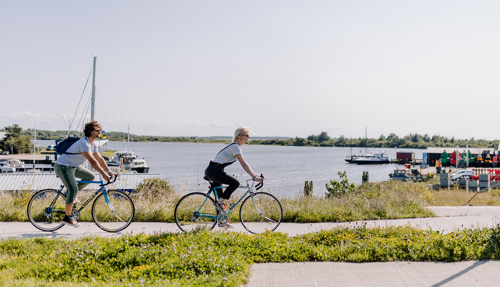 Couple bike along the Lauwersmeer