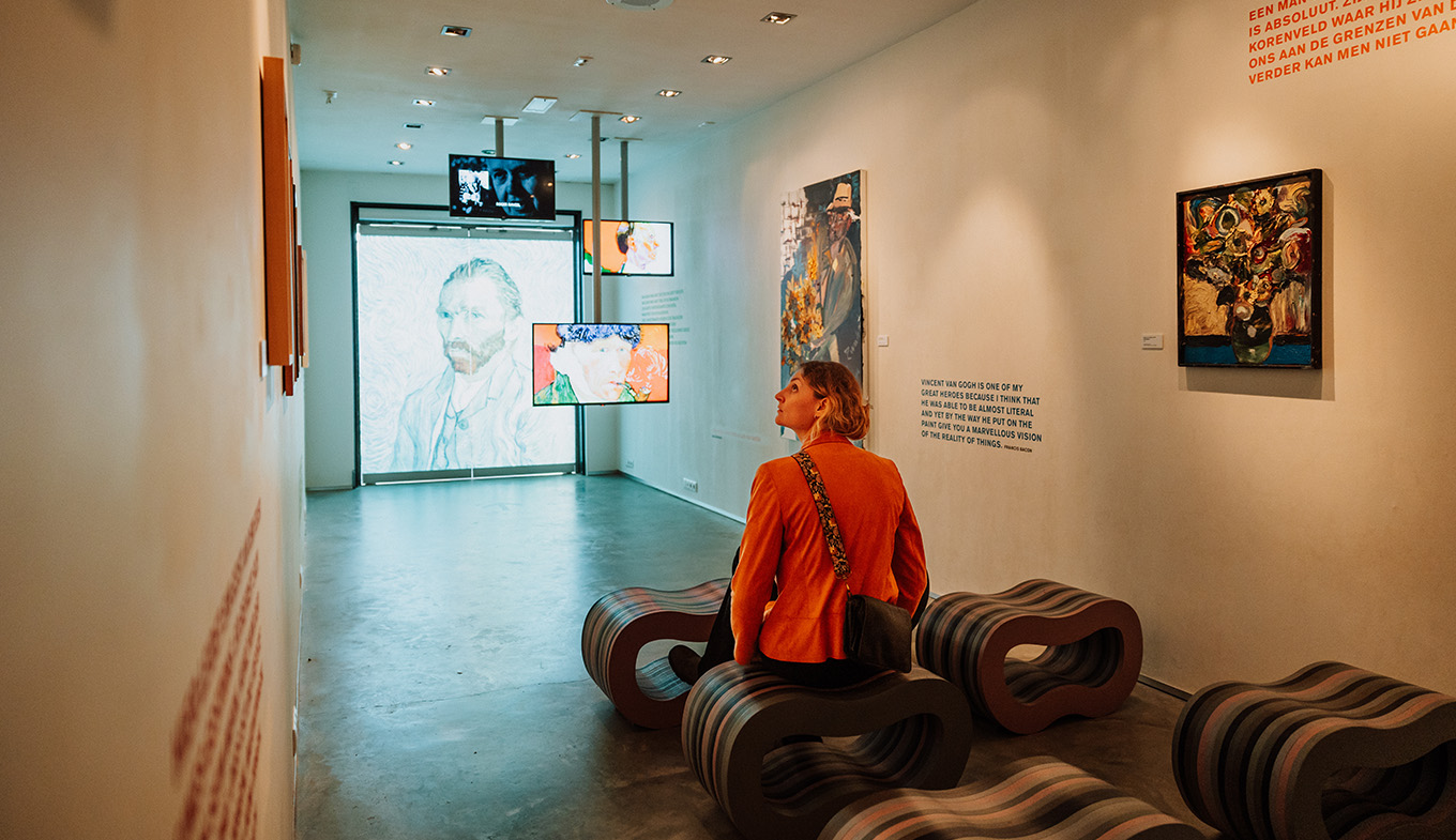 Lady looks at exhibition in Vincent van Gogh House