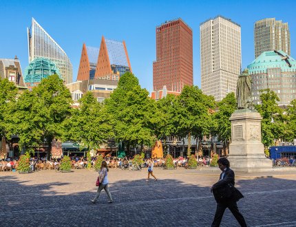 Strollers on the Plein with The Hague skyline in the background