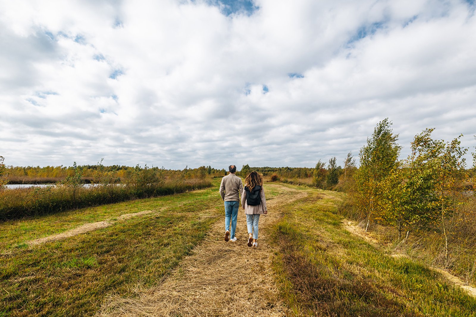 Couple walks on untrodden paths Nature reserve Bargerveen Drenthe