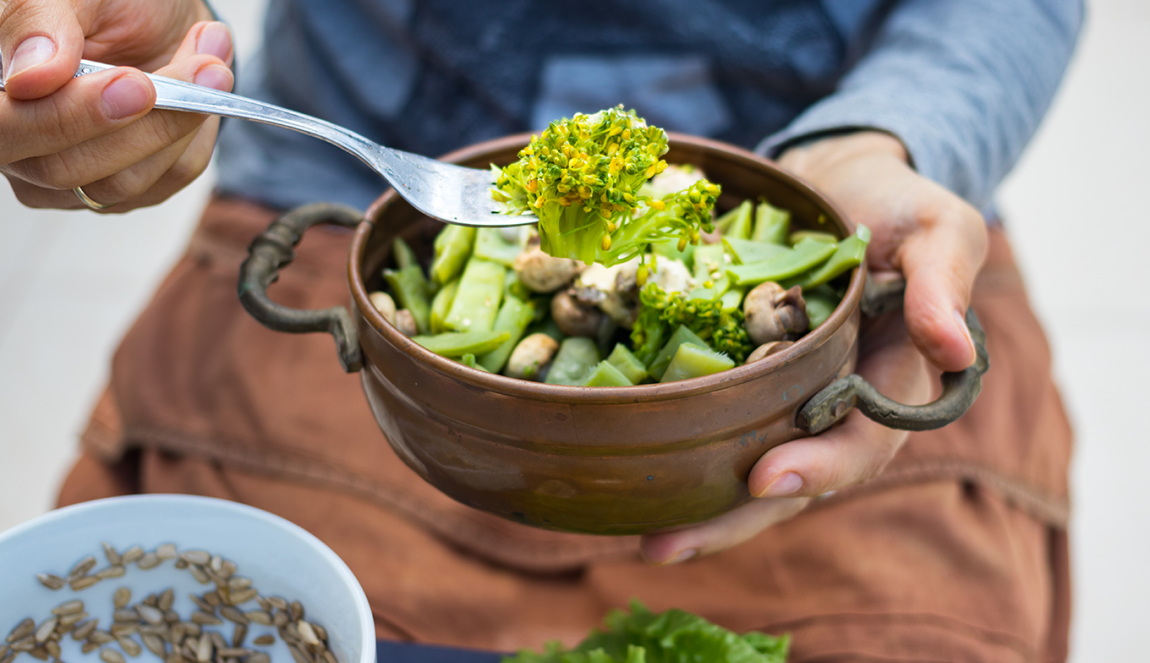 Green greens in a bowl with fork. Vegan vegetarian healty food .